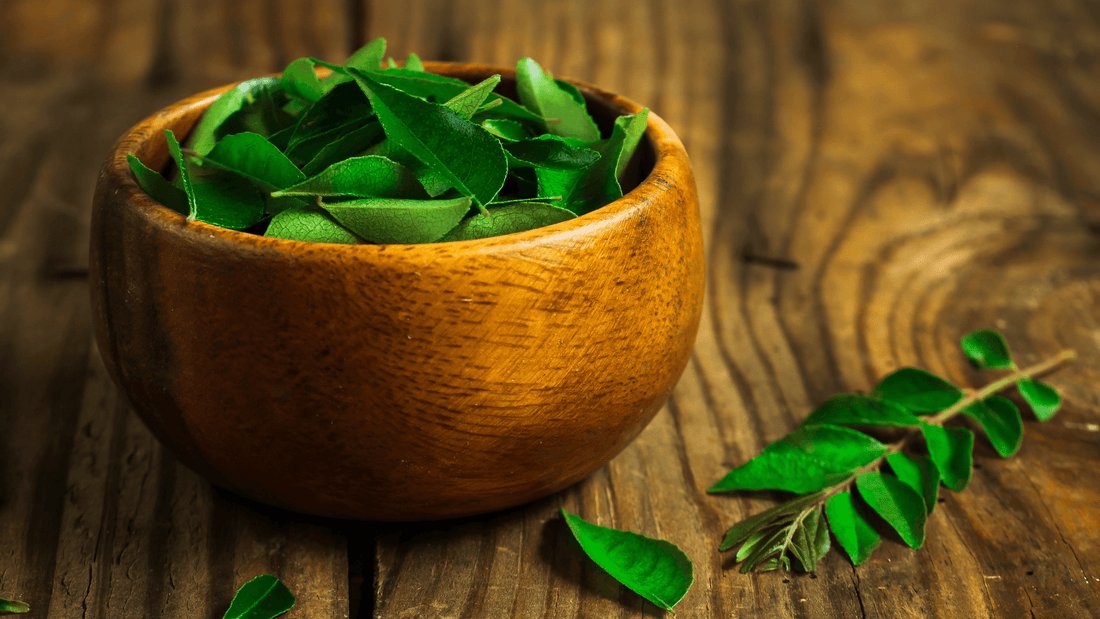 fresh-curry-leaves-in-a-bowl-on-wooden-table